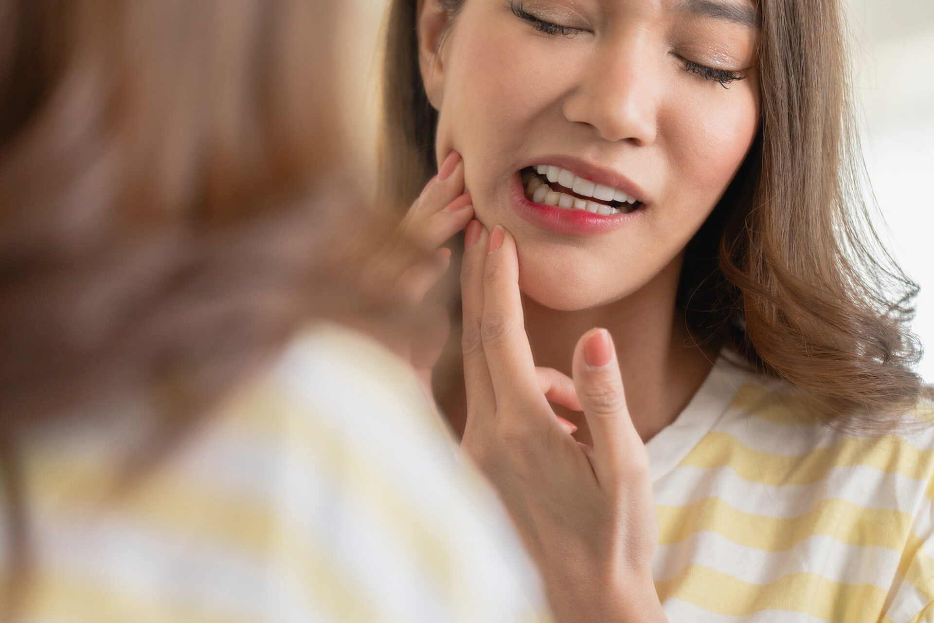 woman with mouth pain from grinding teeth